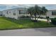 Well-maintained manufactured home with landscaped yard at 208 Marlette Dr, North Port, FL 34287