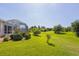 Expansive backyard featuring a large grassy area and screened-in pool area at 283 Long Meadow Ln, Rotonda West, FL 33947