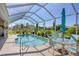 Screened pool and patio with table and chairs for outdoor dining at 283 Long Meadow Ln, Rotonda West, FL 33947
