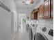 Bright laundry room with washer, dryer, and ample cabinetry at 283 Long Meadow Ln, Rotonda West, FL 33947