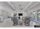 Spacious living room with gray sofas, a large TV, and access to the pool at 283 Long Meadow Ln, Rotonda West, FL 33947