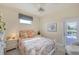 Bright bedroom with pool view, featuring a comfortable bed and access to a patio at 283 Long Meadow Ln, Rotonda West, FL 33947