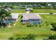 Aerial view of the house and backyard, highlighting the pool and screened enclosure at 283 Long Meadow Ln, Rotonda West, FL 33947