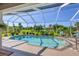 Relaxing screened pool and patio with lush landscaping at 283 Long Meadow Ln, Rotonda West, FL 33947