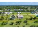 Aerial view of community, showing houses, canal, and lush green landscape at 283 Long Meadow Ln, Rotonda West, FL 33947