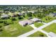 Aerial view of a single-Gathering home with a large backyard and surrounding community at 283 Long Meadow Ln, Rotonda West, FL 33947