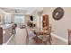 Open concept dining area with glass table and four chairs, view of living room and kitchen at 191 Brig W Cir, Placida, FL 33946