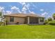 Large backyard with grassy area and screened porch at 191 Brig W Cir, Placida, FL 33946