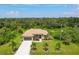 Aerial view of single-Gathering home with driveway and lush landscaping at 191 Brig W Cir, Placida, FL 33946