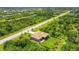 Aerial view showing a house on a quiet street with green surroundings at 191 Brig W Cir, Placida, FL 33946