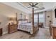 Spacious main bedroom with a post bed, two nightstands, and large window at 191 Brig W Cir, Placida, FL 33946