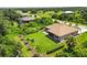 Aerial view of a house with a large backyard and lush landscaping at 191 Brig W Cir, Placida, FL 33946