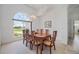 Dining room with large windows overlooking the yard at 15418 Alcove Cir, Port Charlotte, FL 33981