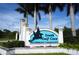 Entrance to South Gulf Cove, a waterfront community with a decorative sign and lush tropical palm trees at 15964 Viscount Cir, Port Charlotte, FL 33981