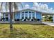 Cute light blue home with covered carport and well-manicured lawn at 740 Summersea Ct, Englewood, FL 34223