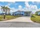 Front view of a light blue manufactured home with carport at 740 Summersea Ct, Englewood, FL 34223