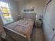 Bedroom with a full-size bed, nightstands, and a dresser at 9174 Bensonhurst Ln, Englewood, FL 34224