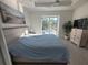 Main bedroom with a king-size bed and access to the backyard pool at 9174 Bensonhurst Ln, Englewood, FL 34224