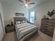 Guest bedroom with a queen-size bed and a large window at 9174 Bensonhurst Ln, Englewood, FL 34224