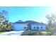 Two-story home with a white exterior, gray roof, and a two-car garage at 9174 Bensonhurst Ln, Englewood, FL 34224
