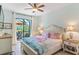 Main bedroom with king-size bed and access to private patio at 15964 Viscount Cir, Port Charlotte, FL 33981