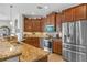 Modern kitchen with wood cabinets, granite countertops and stainless steel appliances at 15964 Viscount Cir, Port Charlotte, FL 33981