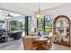 Open dining area with a wood table and access to the pool and lanai at 15964 Viscount Cir, Port Charlotte, FL 33981