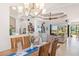 Open dining room with hardwood table and view of living room and pool at 15964 Viscount Cir, Port Charlotte, FL 33981