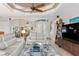 Bright living area with comfy sofas, a large TV, and access to the dining area at 15964 Viscount Cir, Port Charlotte, FL 33981