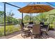 Covered patio with table and chairs, perfect for outdoor dining at 15964 Viscount Cir, Port Charlotte, FL 33981