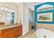 Spa-like bathroom with a soaking tub, walk-in shower, and granite vanity at 15964 Viscount Cir, Port Charlotte, FL 33981