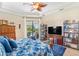 Relaxing main bedroom with king-size bed, built-in shelving, and sliding doors to the pool at 15964 Viscount Cir, Port Charlotte, FL 33981