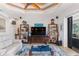 Relaxing living room with comfortable seating, built-in shelving, and backyard access at 15964 Viscount Cir, Port Charlotte, FL 33981