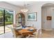 Casual dining area with a wood table and seating for four, overlooking the backyard at 15964 Viscount Cir, Port Charlotte, FL 33981