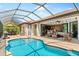 Inviting pool area with covered patio and outdoor seating at 15964 Viscount Cir, Port Charlotte, FL 33981