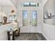 Elegant entryway with double doors, stained glass, and a glass-top console table at 15964 Viscount Cir, Port Charlotte, FL 33981