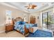 Relaxing main bedroom with a king-size bed, ample natural light, and access to the pool at 15964 Viscount Cir, Port Charlotte, FL 33981