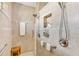 Walk-in shower with grab bars and built-in shelving, perfect for accessibility at 15964 Viscount Cir, Port Charlotte, FL 33981