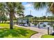 Private boat dock with covered lift and lush landscaping at 15964 Viscount Cir, Port Charlotte, FL 33981