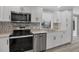 Modern kitchen with white cabinets and geometric backsplash at 740 Summersea Ct, Englewood, FL 34223