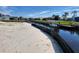 View of a canal with sandy bank and erosion control at 2614 Oberon Rd, Englewood, FL 34224