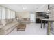 Living room with neutral-toned couches and a view into the kitchen at 301 W Fray St, Englewood, FL 34223