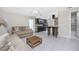 Living room features neutral colored couch and kitchen with dark wood cabinets at 301 W Fray St, Englewood, FL 34223