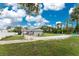 Large backyard with grassy area and gravel driveway at 301 W Fray St, Englewood, FL 34223