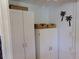 White storage cabinets and wicker baskets in a bright storage room at 6246 Parakeet Rd, Englewood, FL 34224