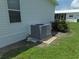 Grey AC unit on a concrete slab near the house at 6246 Parakeet Rd, Englewood, FL 34224