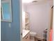 Clean bathroom with toilet, sink, and built-in shelving at 6246 Parakeet Rd, Englewood, FL 34224