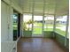 Spacious screened porch with tiled floor and view of the community at 6246 Parakeet Rd, Englewood, FL 34224