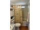 Bathroom with tub, seashell shower curtain, and wood floor at 6246 Parakeet Rd, Englewood, FL 34224