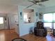 Living room with hardwood floors, a recliner, and a view into the kitchen at 6246 Parakeet Rd, Englewood, FL 34224